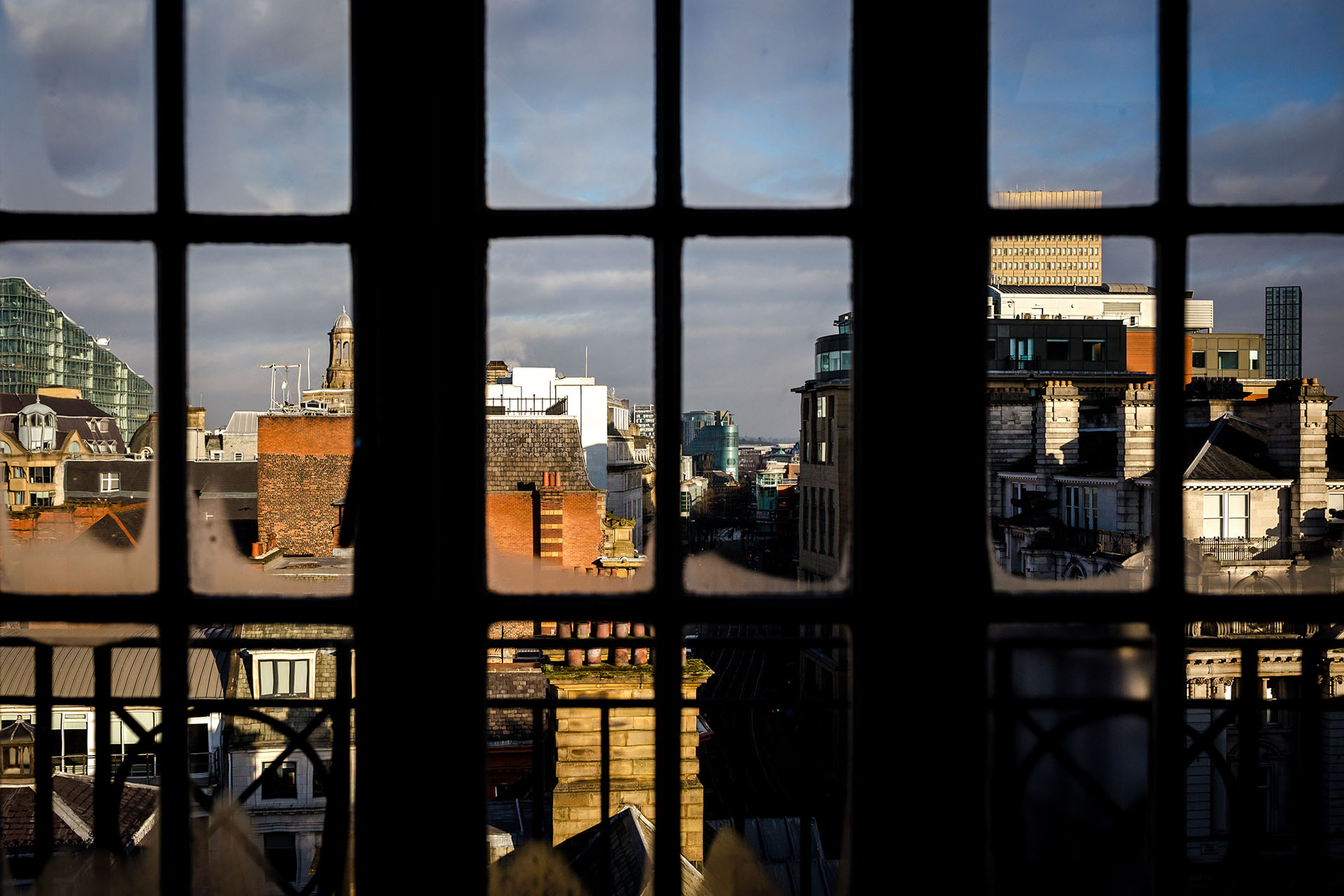 image looking out of a window overlooking a city skyline